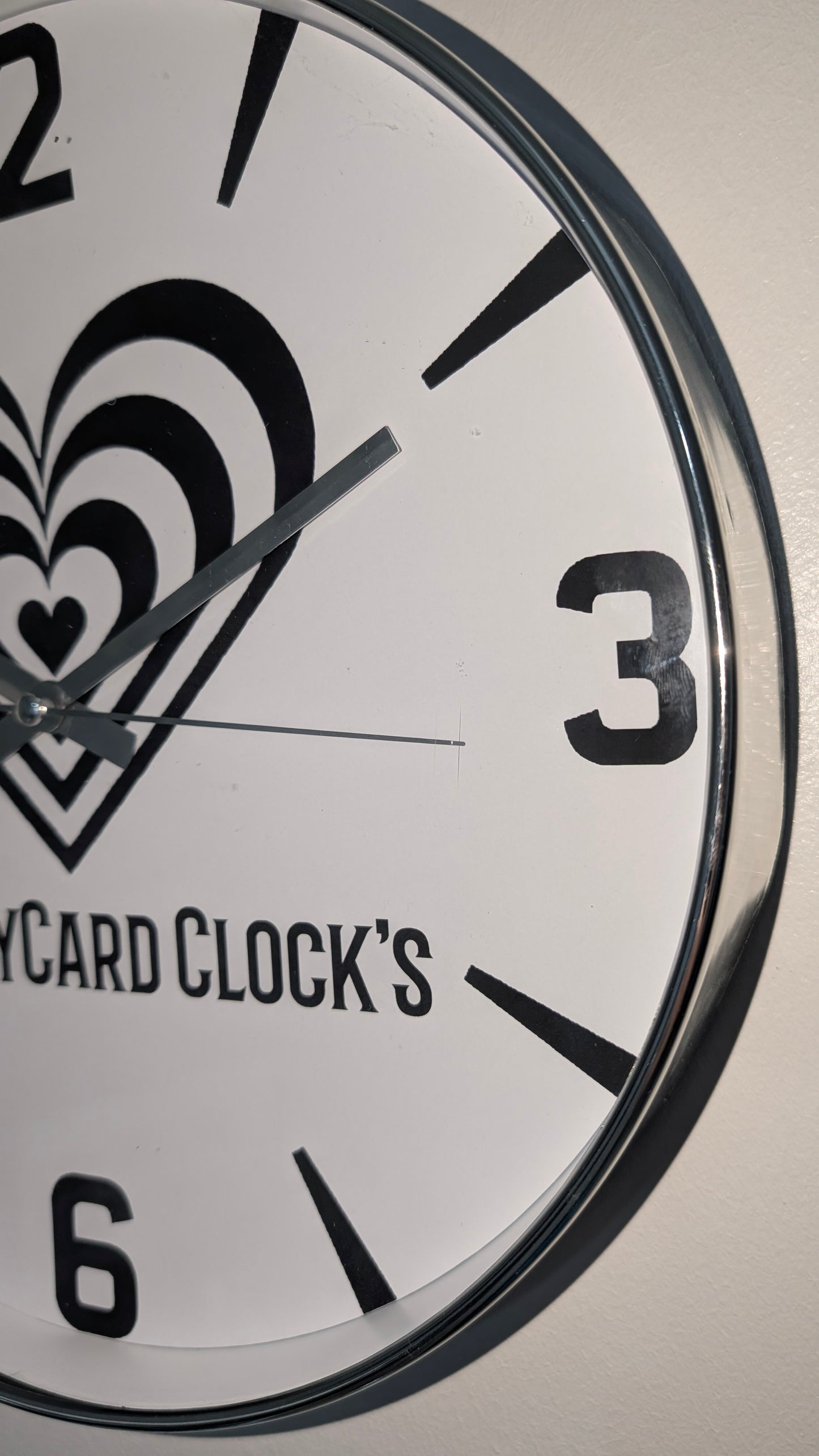 Wall clock with 'NaughtyCard Clock's' branding on a white background