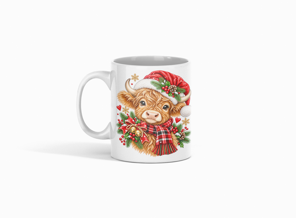 A white ceramic mug featuring a festive illustration of a Scottish highland cow wearing a red Santa hat and plaid scarf, surrounded by green holly leaves and red berries, on a clean white background.