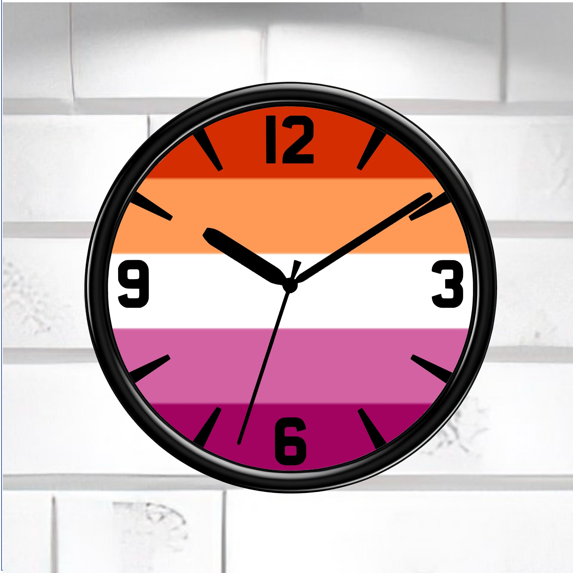 Wall clock with a colorful striped lesbian pride flag design on a white brick wall background