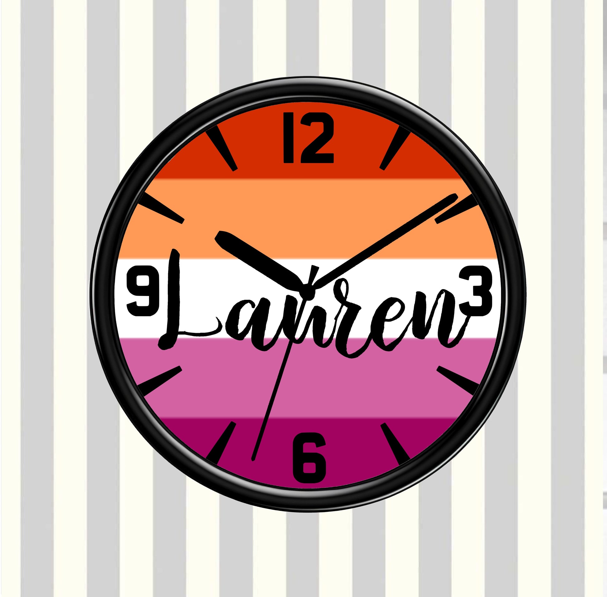 Wall clock with rainbow gsy pride flag design and 'Lauren' text on a striped background