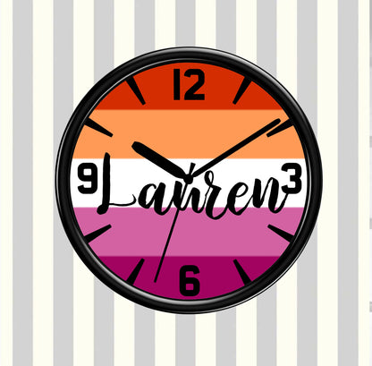 Wall clock with rainbow gsy pride flag design and 'Lauren' text on a striped background