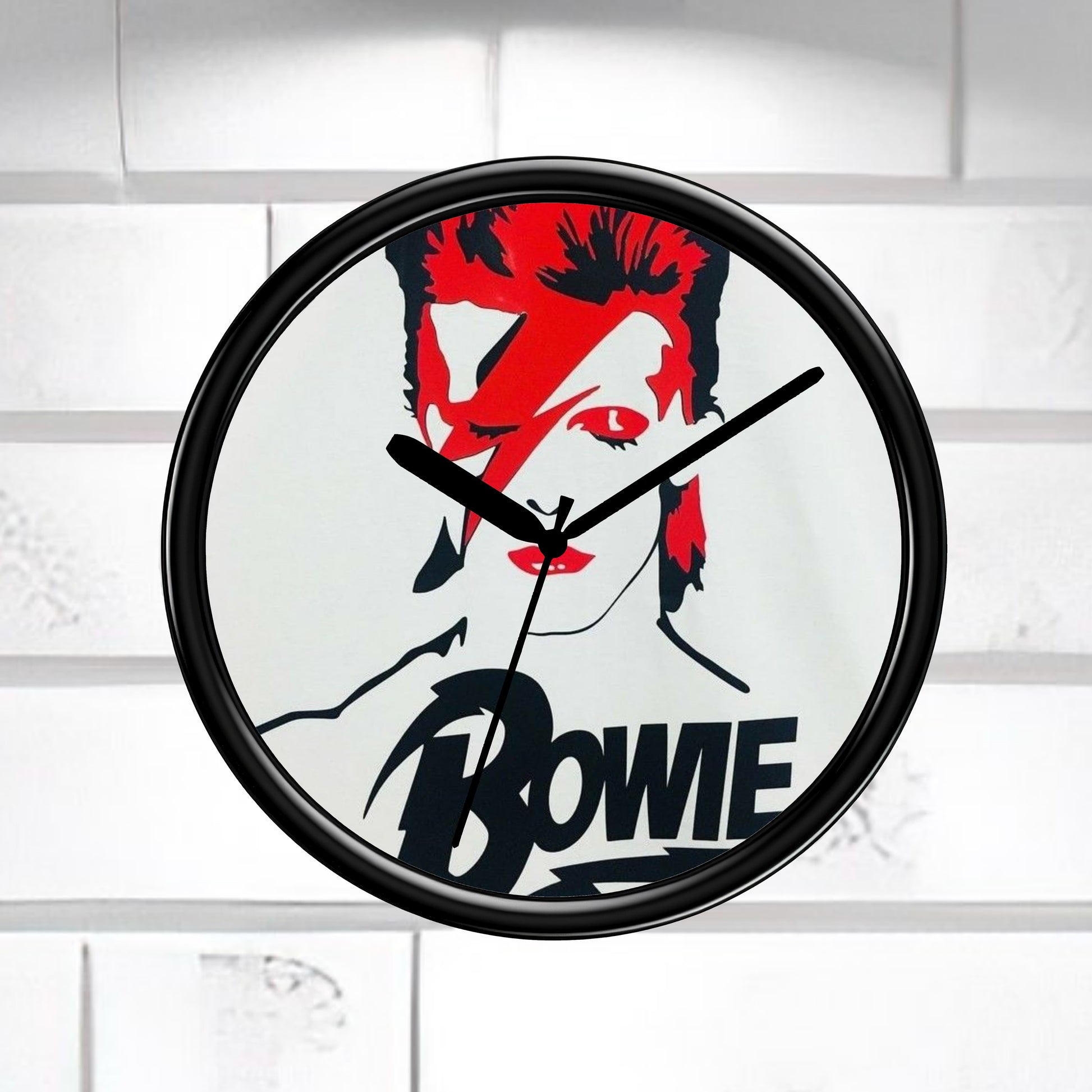 Wall clock with a design of a face with red hair and the name 'Bowie' on a white background.