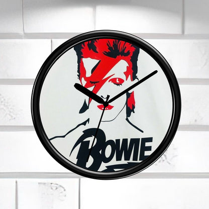 Wall clock with a design of a face with red hair and the name 'Bowie' on a white background.
