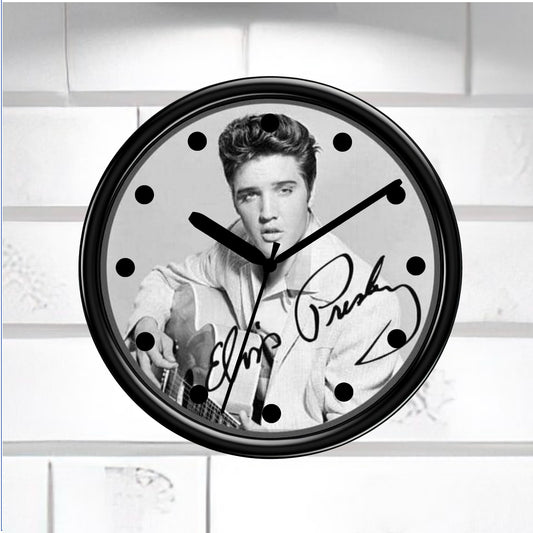 Wall clock with a black and white portrait of a famous person and signature on a light background