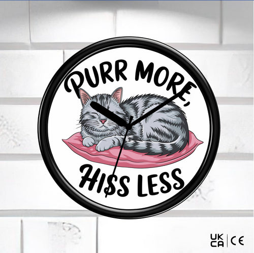 Black Wall Clock on a white tile background face of clock is a cat with the saying Purr more hiss less