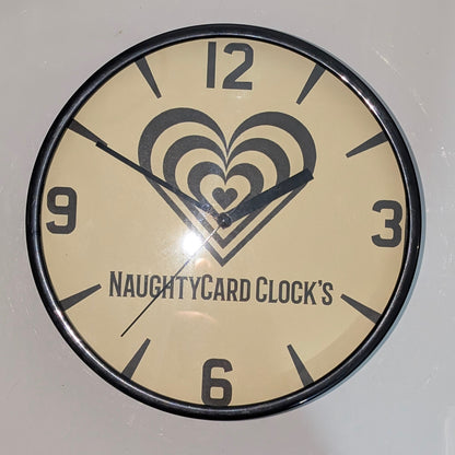 Front view of black wall clock on plain white background