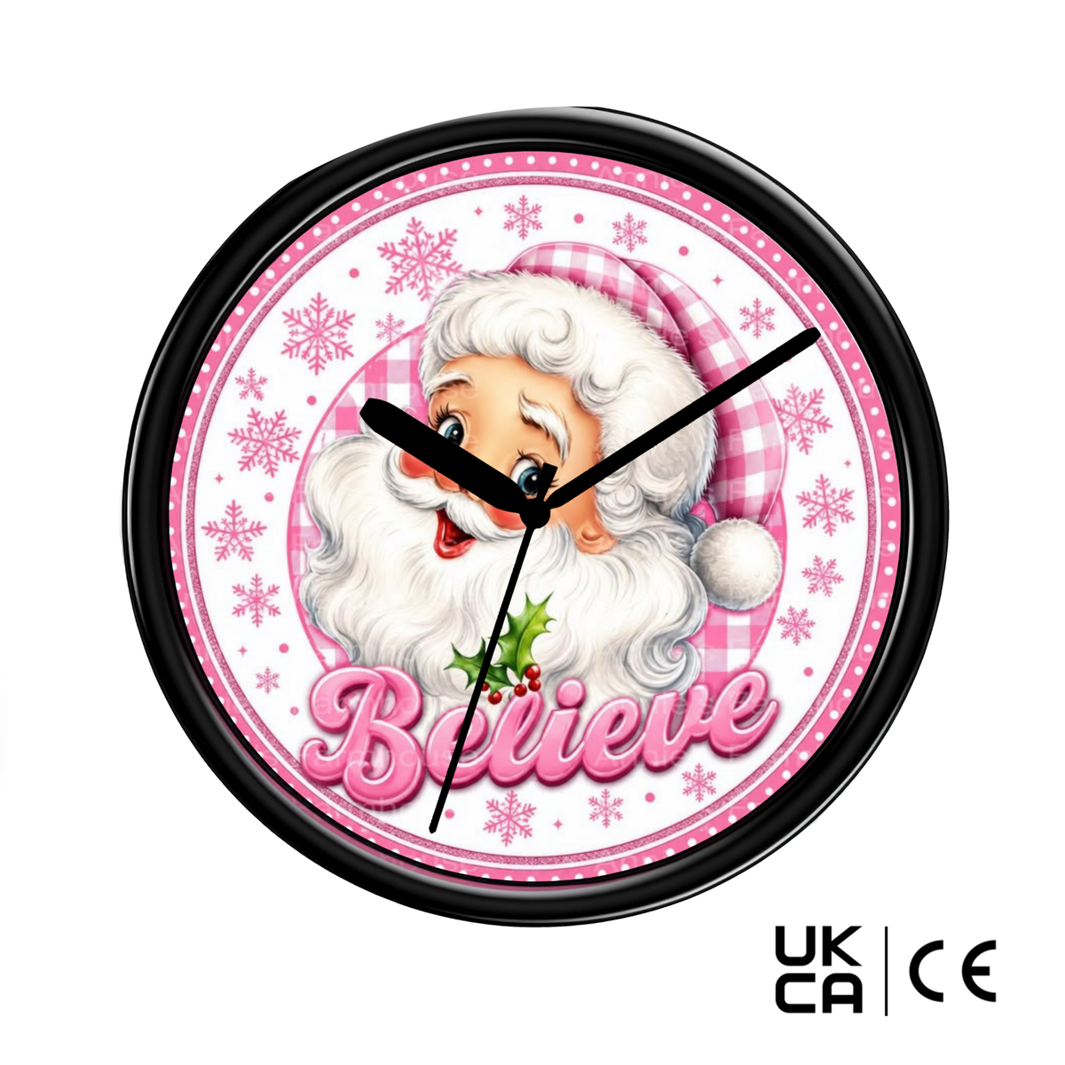 A round wall clock with a black frame and a festive Santa Claus design. The clock face features a pink and white gingham pattern, pink snowflakes, the word 'Believe' in pink script, and black clock hands.