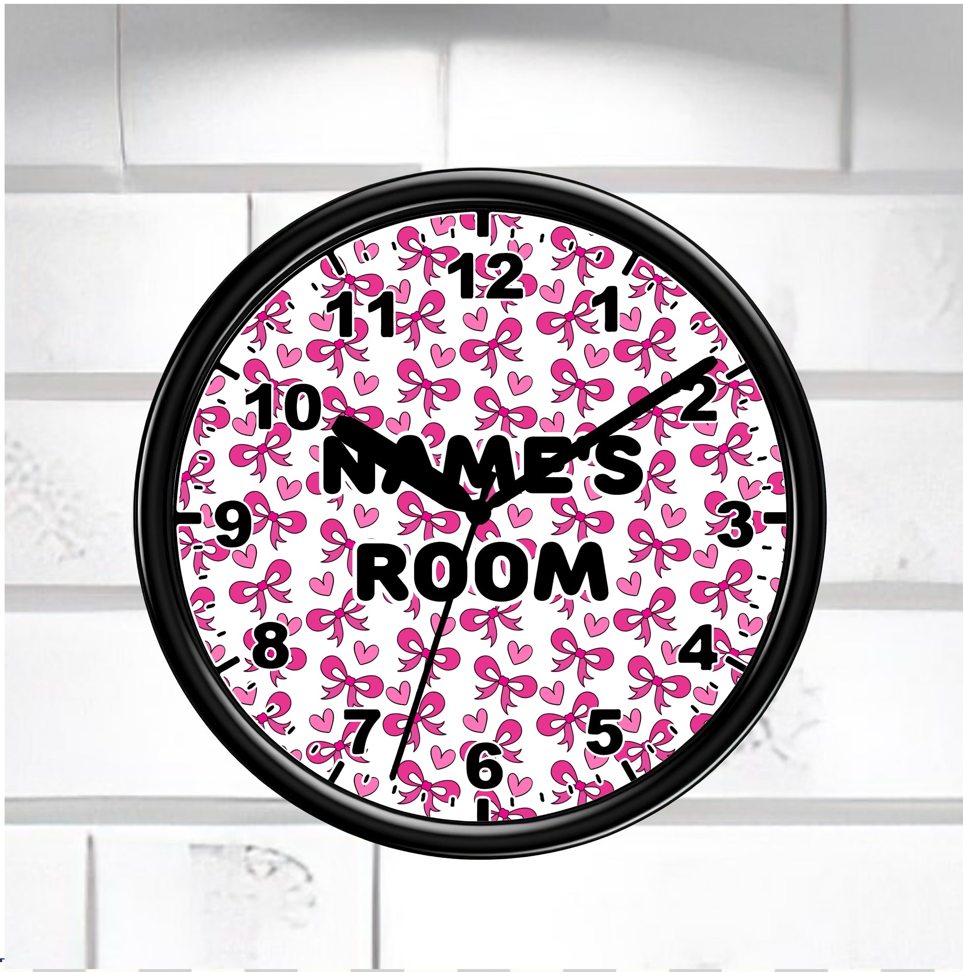Wall clock with pink bow pattern "Names Room" on a white brick wall background