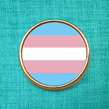Gold Lapel Badge on a green background featuring the transgender pride flag design