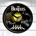 Wall clock featuring The Beatles' Abbey Road album cover with signatures on a white background