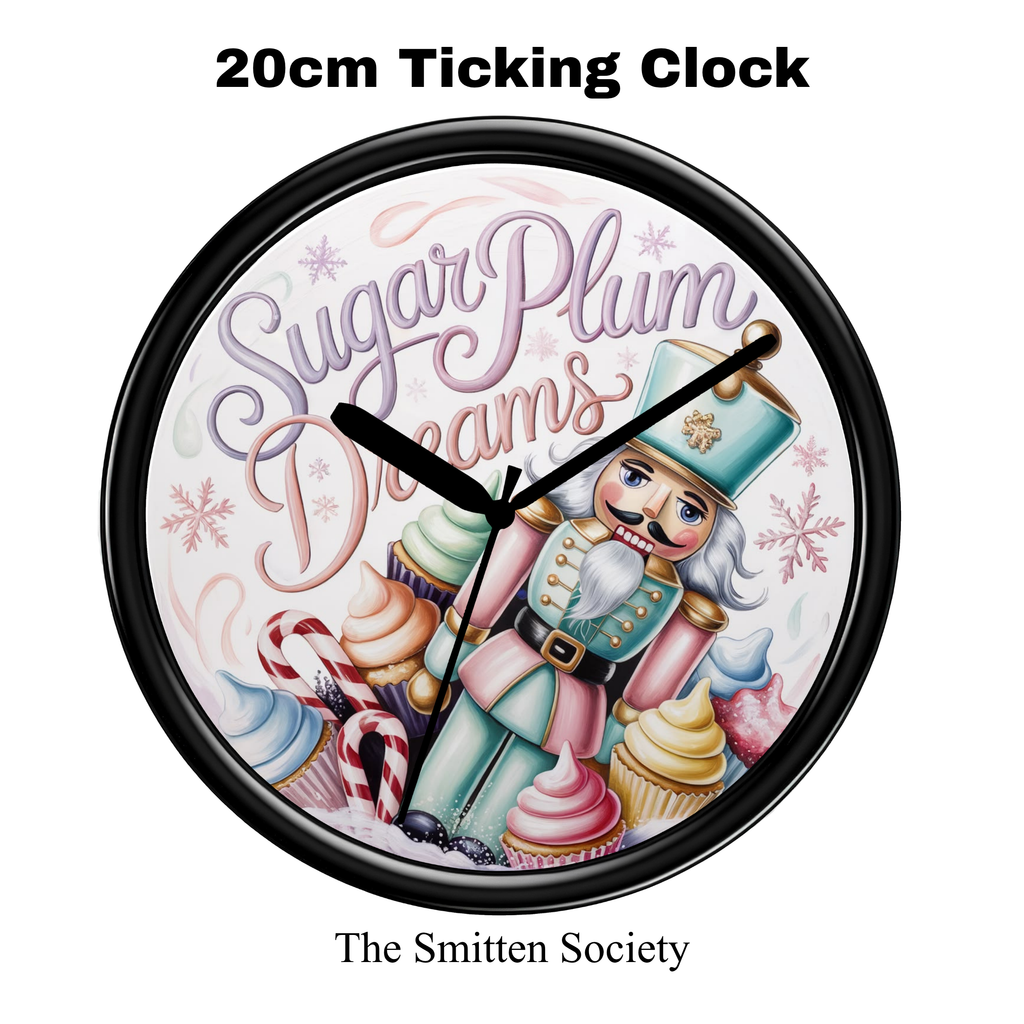 A round black-framed wall clock with a whimsical nutcracker illustration and the words 'Sugar Plum Dreams' on a white background. Text above reads '20cm Ticking Clock' and text below reads 'The Smitten Society'.
