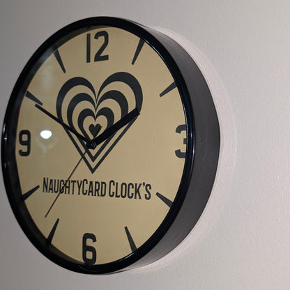 Right side view of black plastic wall clock from NaughtyCard - Value clock on plain wall