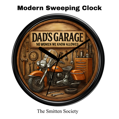 Wall clock with 'Dad's Garage' theme featuring a motorcycle and tools, branded 'The Smitten Society'.