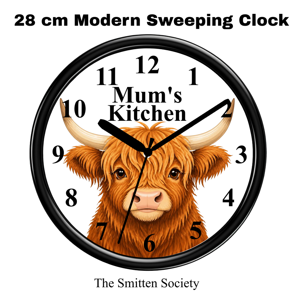 A round wall clock with a black frame and a white face featuring a detailed illustration of a brown highland cow. The clock face includes black Arabic numerals and the text 'Mum's Kitchen' across the center.