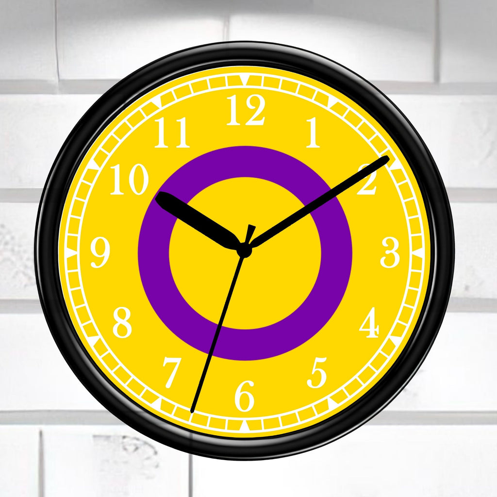 Intersex Pride Flag Wall clock with yellow face, purple circle, and black frame on a white brick wall background