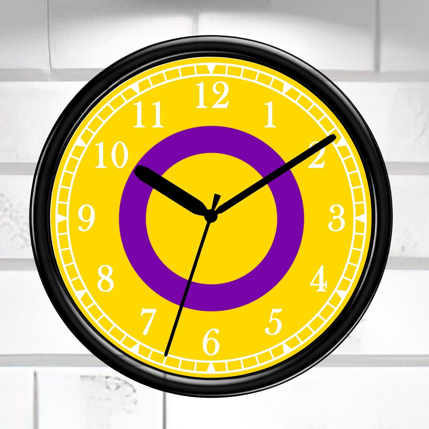 Intersex Pride Flag Wall clock with yellow face, purple circle, and black frame on a white brick wall background