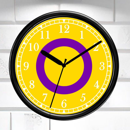 Intersex Pride Flag Wall clock with yellow face, purple circle, and black frame on a white brick wall background