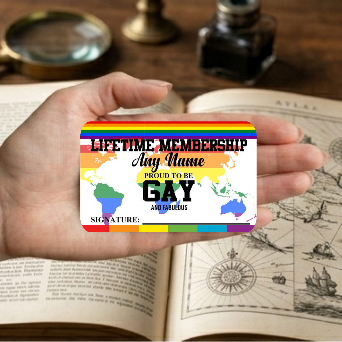 Hand holding a rainbow-colored card with text on an open book