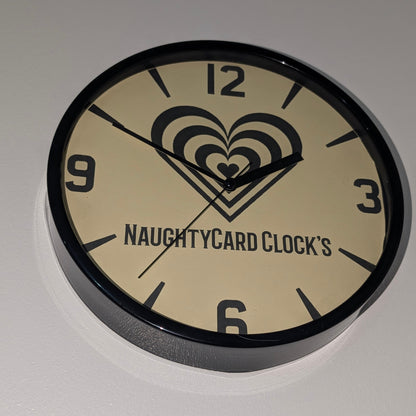Bottom view of black plastic value wall clock from NaughtyCard, on a plain white background. Showing the clock from all angels. 