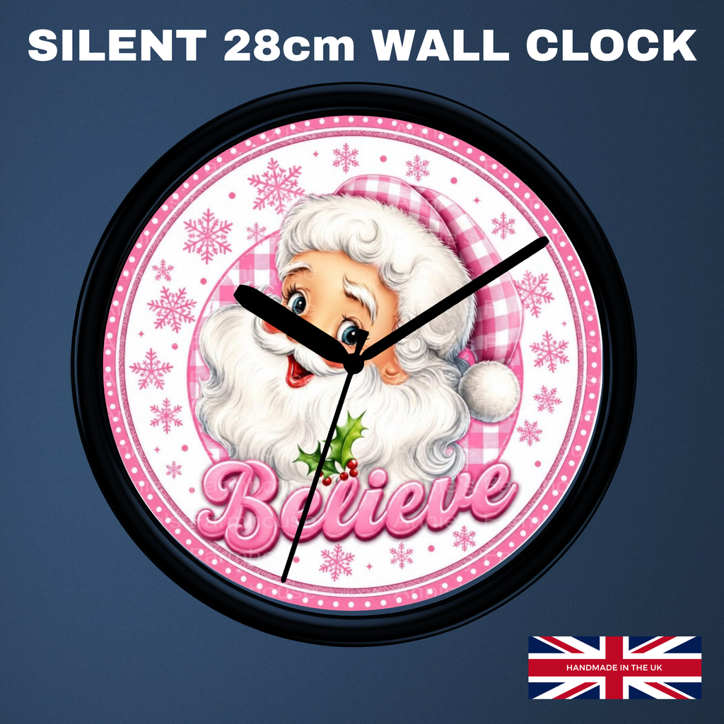 A round wall clock with a black frame and a festive Santa design. The clock face is white with pink gingham accents, snowflakes, and the word 'Believe' in pink script.