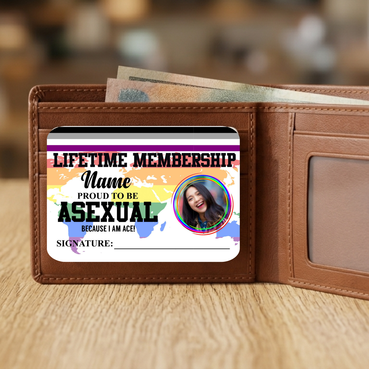 Wallet with a card inside reading 'Lifetime Membership: Proud to be Asexual' on a wooden surface.