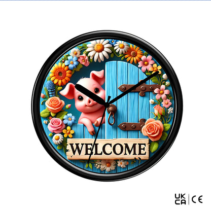 Wall clock on a plain white background, featuring a pig and a sign saying "welcome"