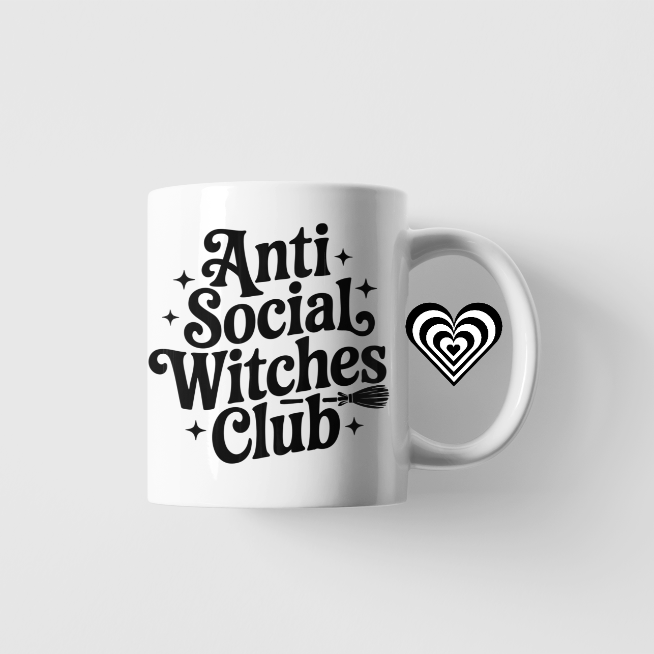 White mug with 'Anti Social Witches Club' text on a light gray background