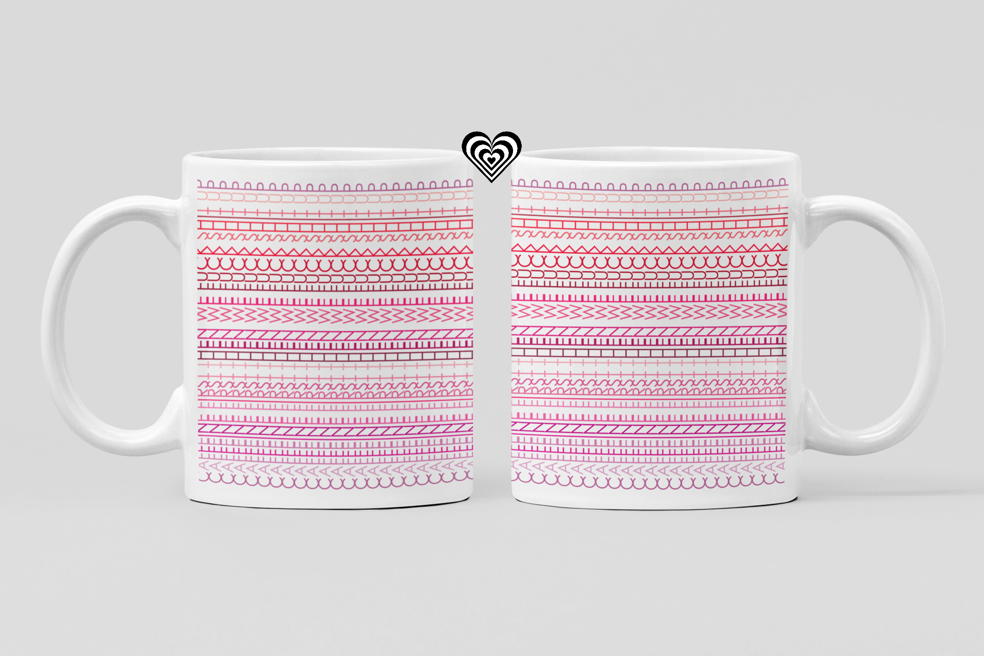 Two white mugs with pink patterned designs on a light gray background