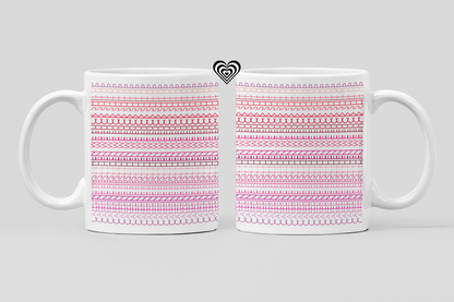 Two white mugs with pink patterned designs on a light gray background