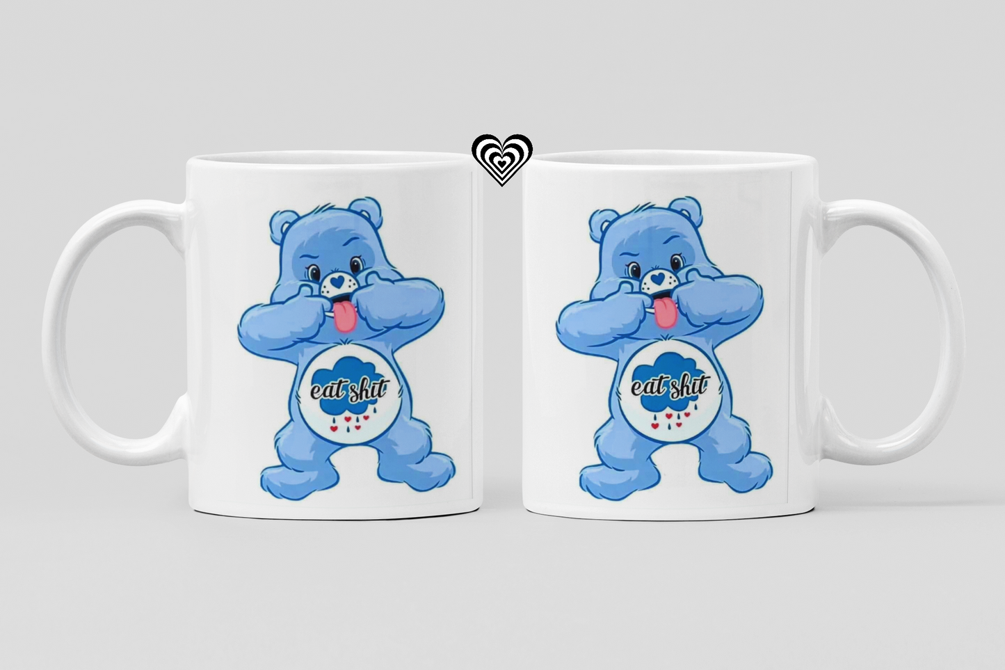 Two white mugs with blue cartoon naughty bears and 'eat sh*t' text on a light gray background
