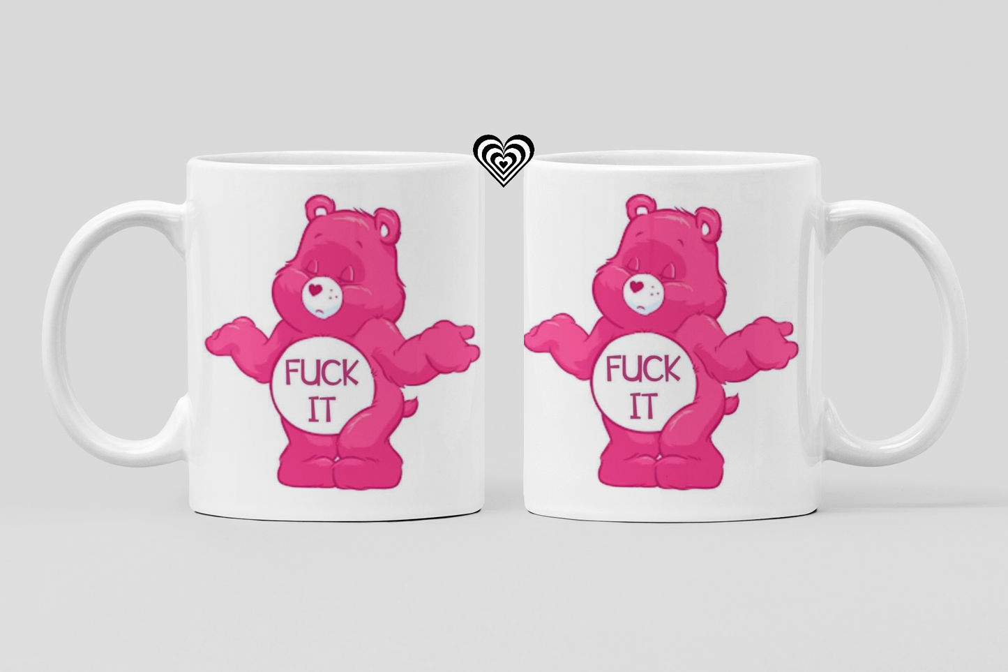 Two white mugs with pink bear graphics and text "F*ck it" on a light gray background