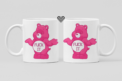 Two white mugs with pink bear graphics and text "F*ck it" on a light gray background