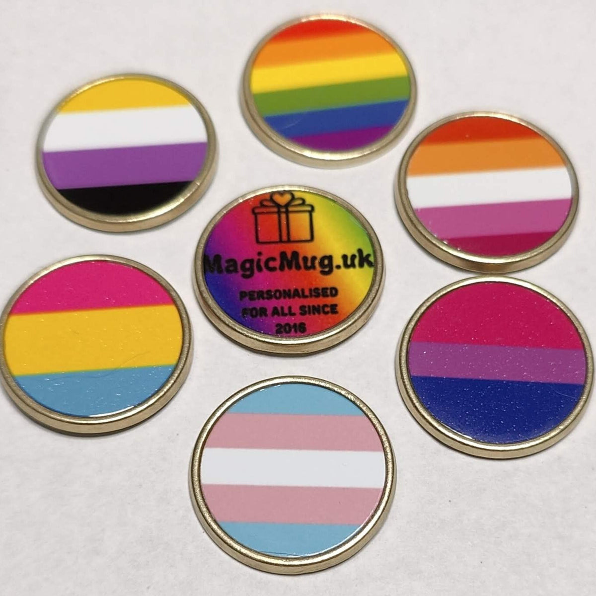 Gay pride pin badges, 7 gay pride flags on lapel pin badges on a plain white background