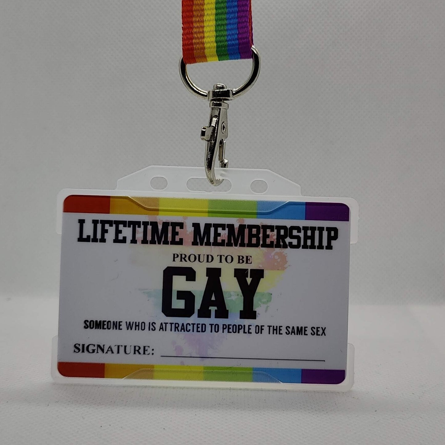 A Metal Gay Membership card with a rainbow-colored border and a personalized message that reads 'Lifetime Membership PROUD TO BE GAY' along with a signature line.