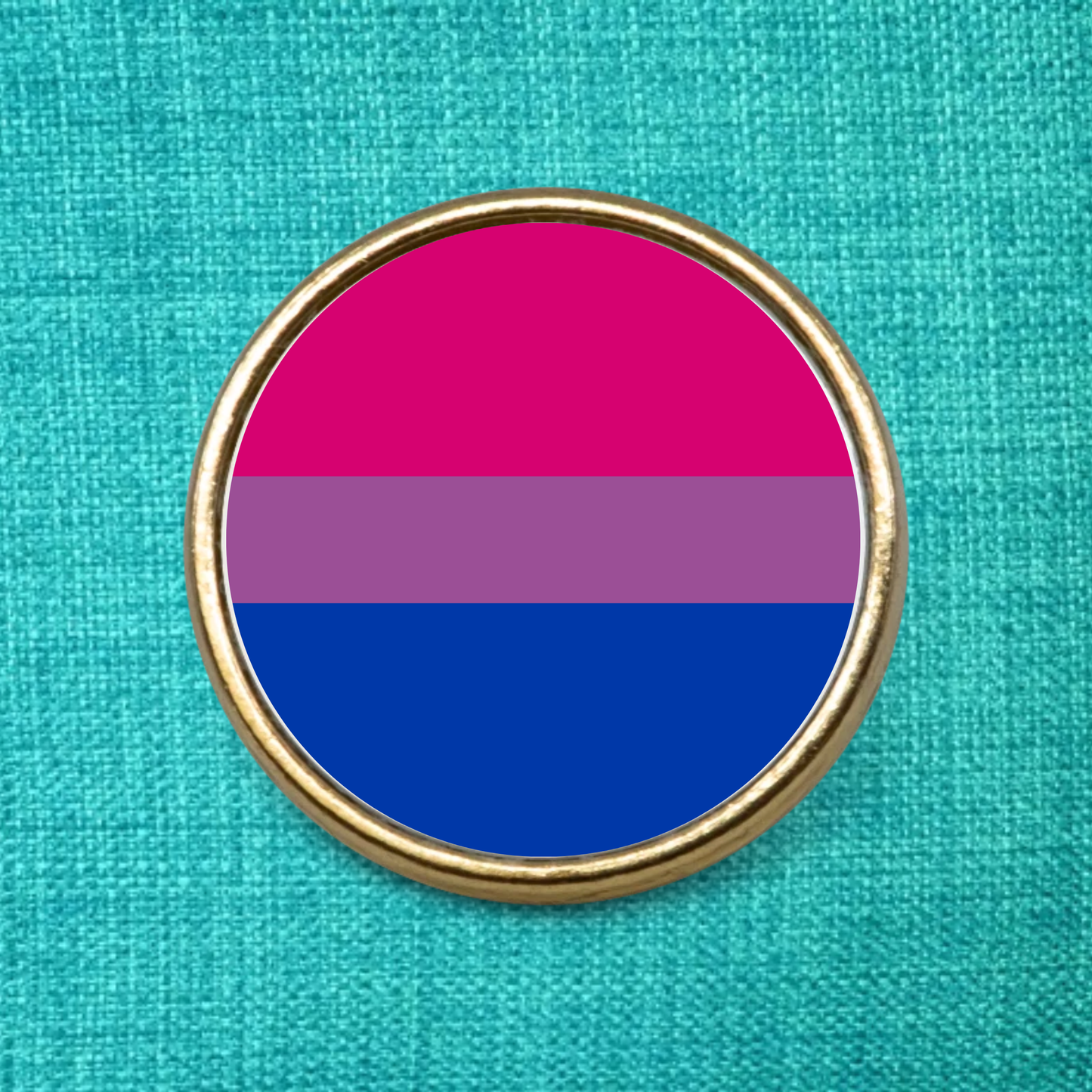 Gold lapel badge featuring the bisexual LGBTQ Pride Flag on a green textured background