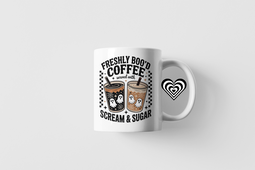 White mug with Halloween-themed coffee design on a white background