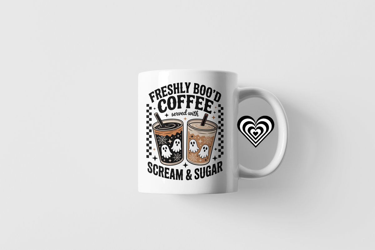 White mug with Halloween-themed coffee design on a white background