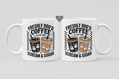 Two white mugs with Halloween-themed coffee design on a light gray background