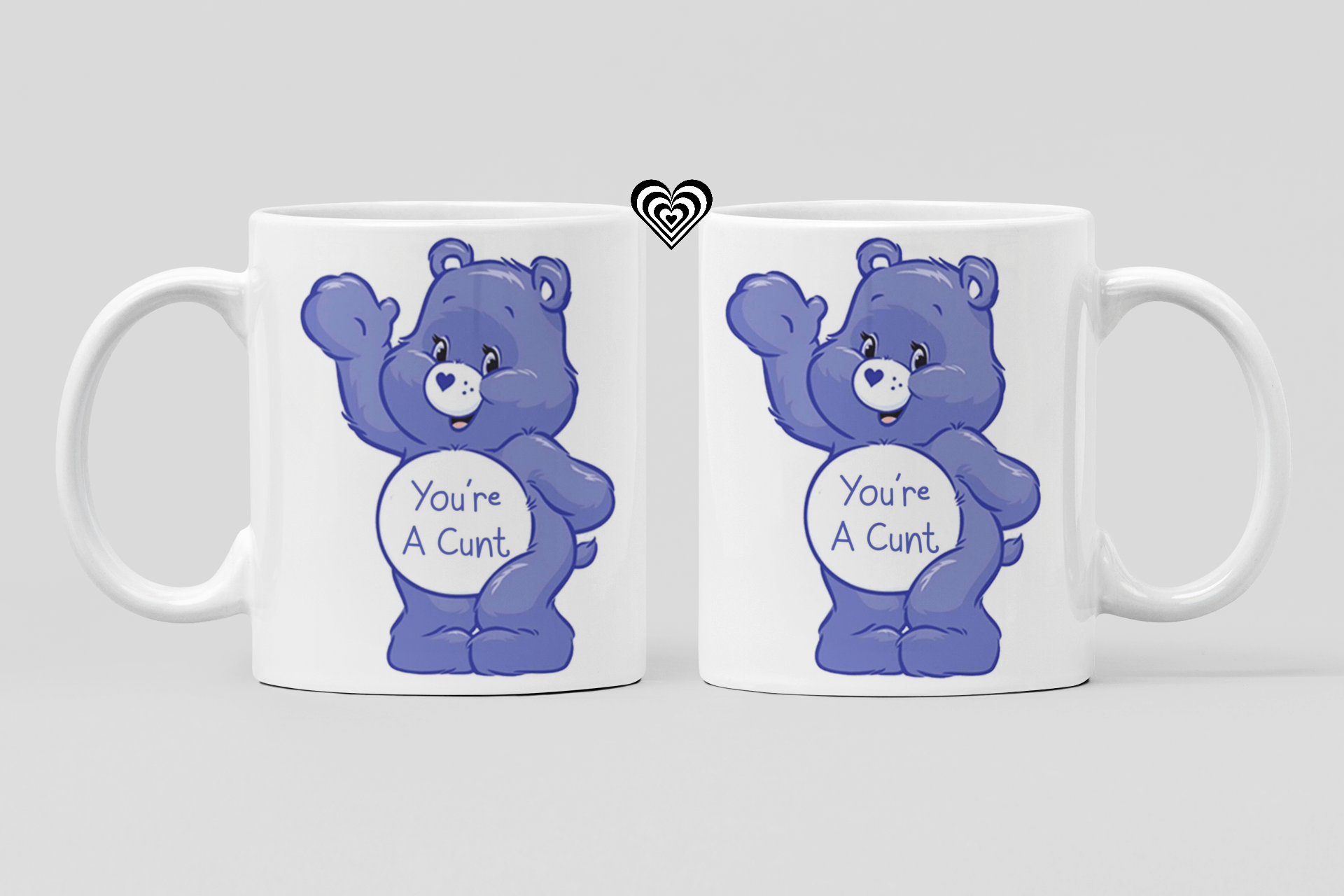 Two mugs with blue bears and offensive text on a light gray background