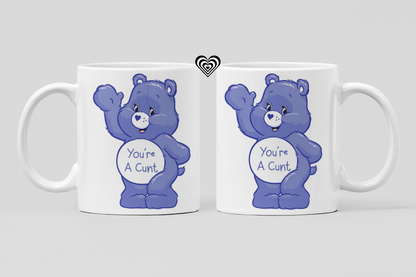 Two mugs with blue bears and offensive text on a light gray background