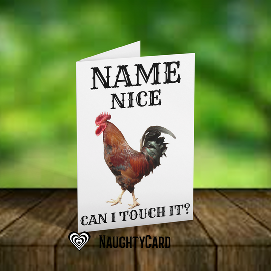 Card with a rooster illustration and text on a wooden surface with a blurred green background