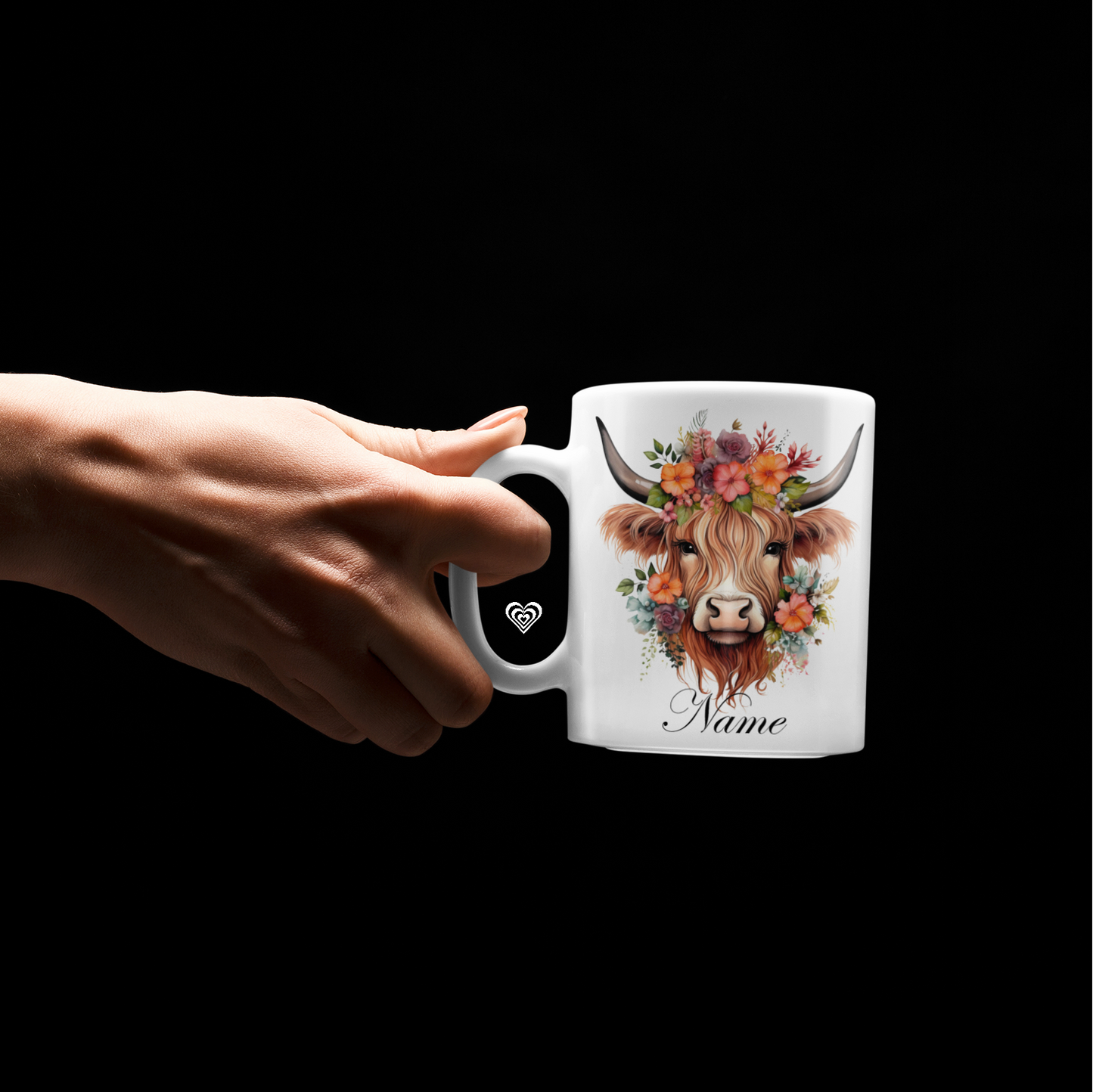 White mug with a highland cow and text reading "Name" with a hand holding the mug handle