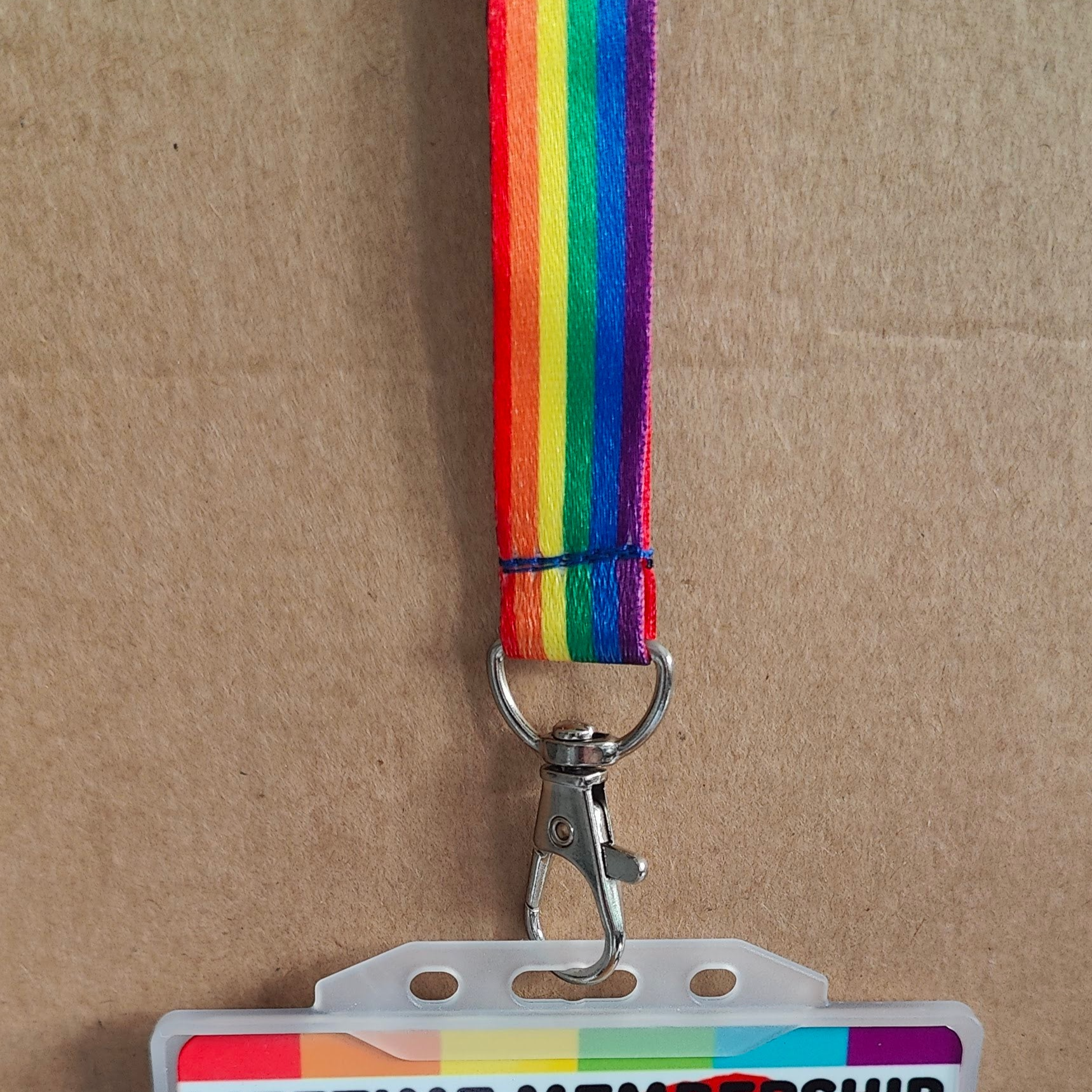 LGBTQ Pride lanyard on a brown cardboard background