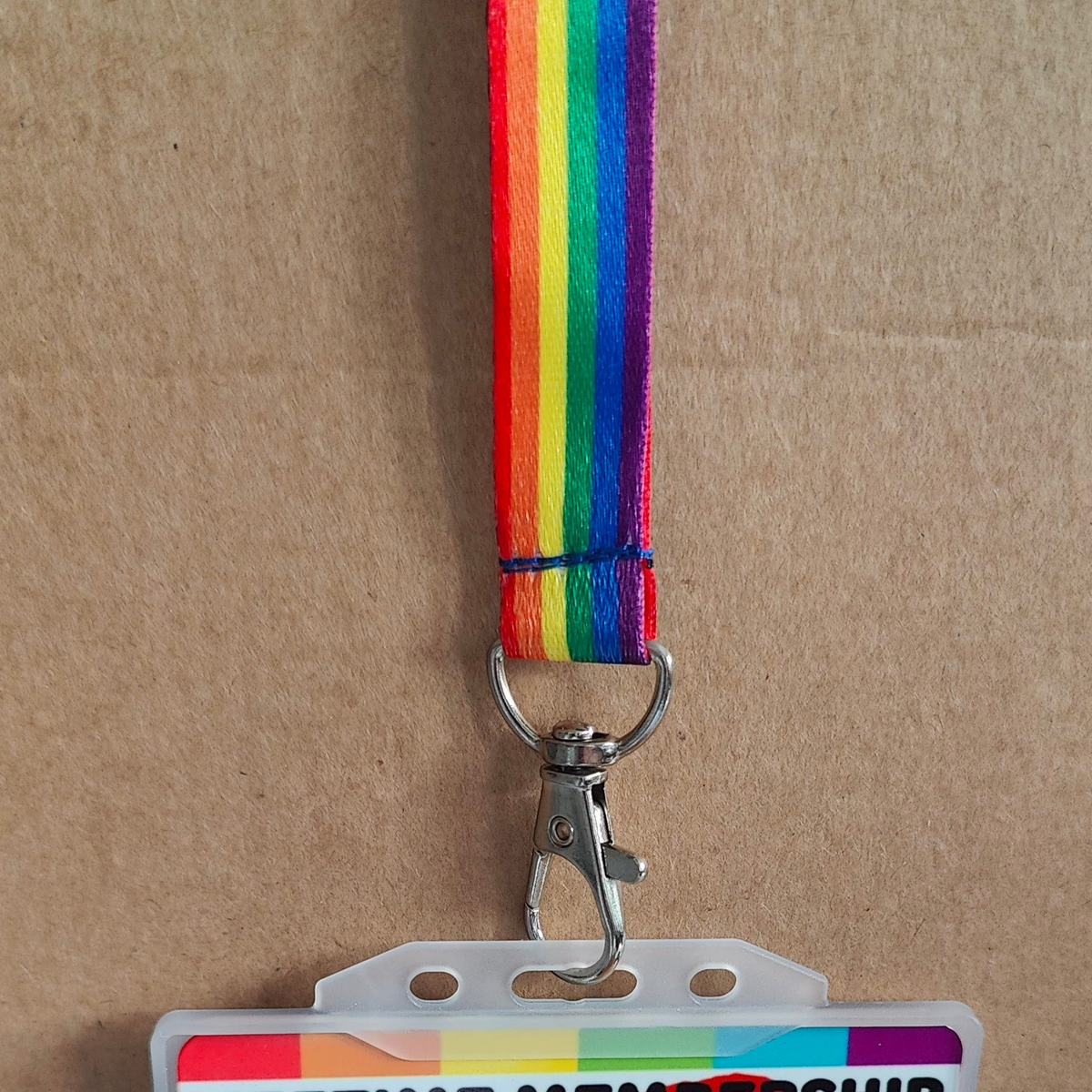 LGBTQ Pride lanyard on a brown cardboard background