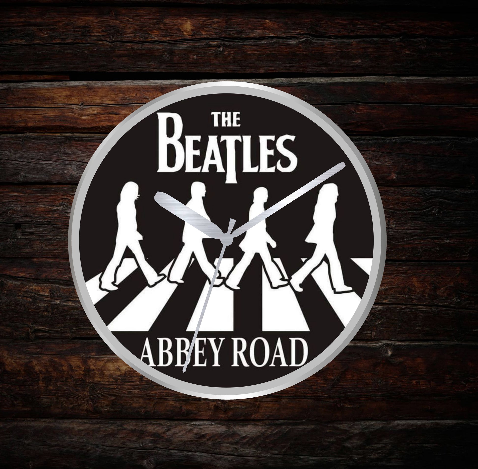 Circular clock with The Beatles Abbey Road design on a wooden background